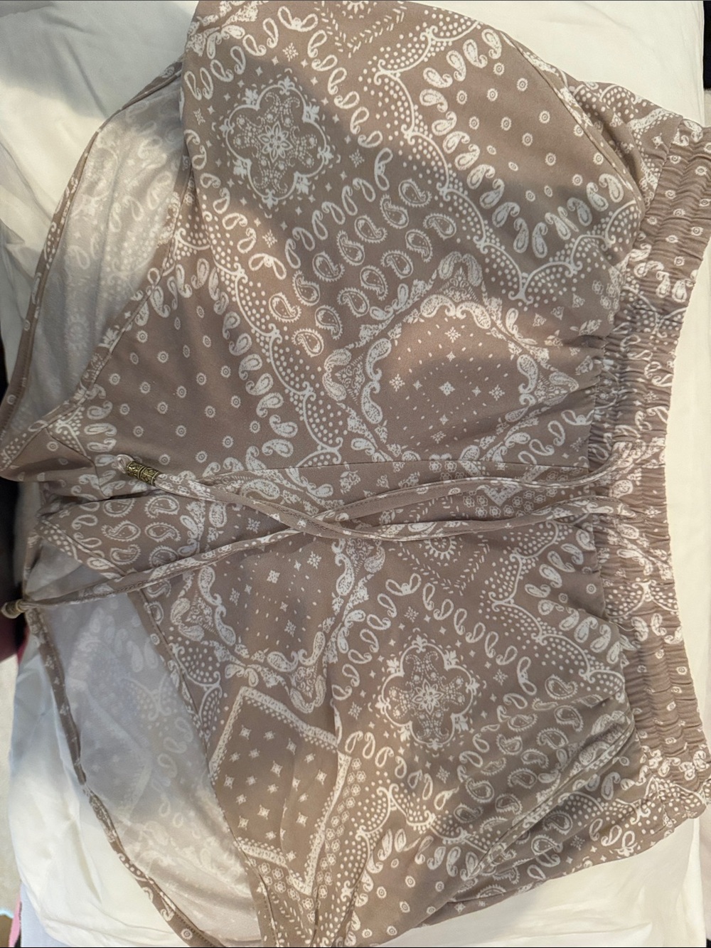Pink Rose drawstring shorts having a neutral tan, cream paisley bandana print.